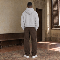 Man seen from behind wearing the SERENOS Best Day oversized boxy hoodie in flower gray, plain back and dropped shoulders, cropped boxy fit