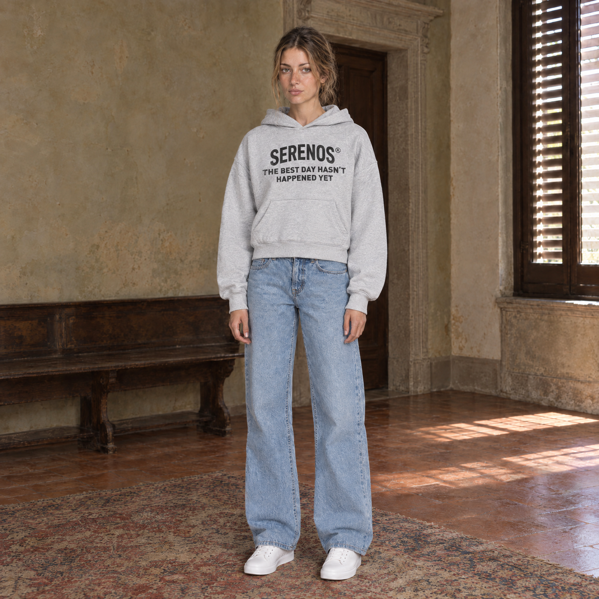Woman wearing the SERENOS Best Day oversized boxy hoodie in flower gray, chest print reading The best day hasn't happened yet, cropped boxy fit