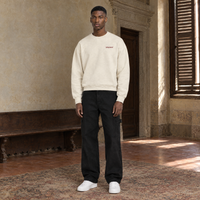 Man wearing the SERENOS Door long sleeve in apricot, front view with the small chest logo