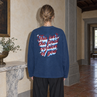 Woman seen from behind wearing the navy SERENOS Final Version long sleeve tee with the This Isn't The Final Version Of You back print