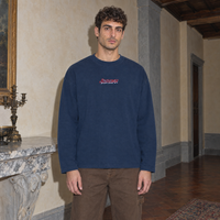 Man wearing the navy SERENOS Final Version long sleeve tee front view with the red script Serenos chest logo