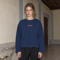 Woman wearing the navy SERENOS Final Version long sleeve tee front view with the red script Serenos chest logo