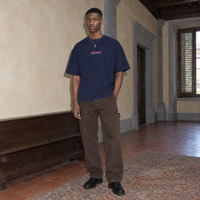 Man wearing the SERENOS Final Version T-Shirt in navy blue, front view with centred chest logo