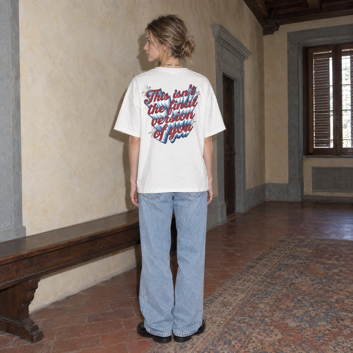 Woman wearing the SERENOS Final Version T-Shirt in white, back print reading This isn't the final version of you