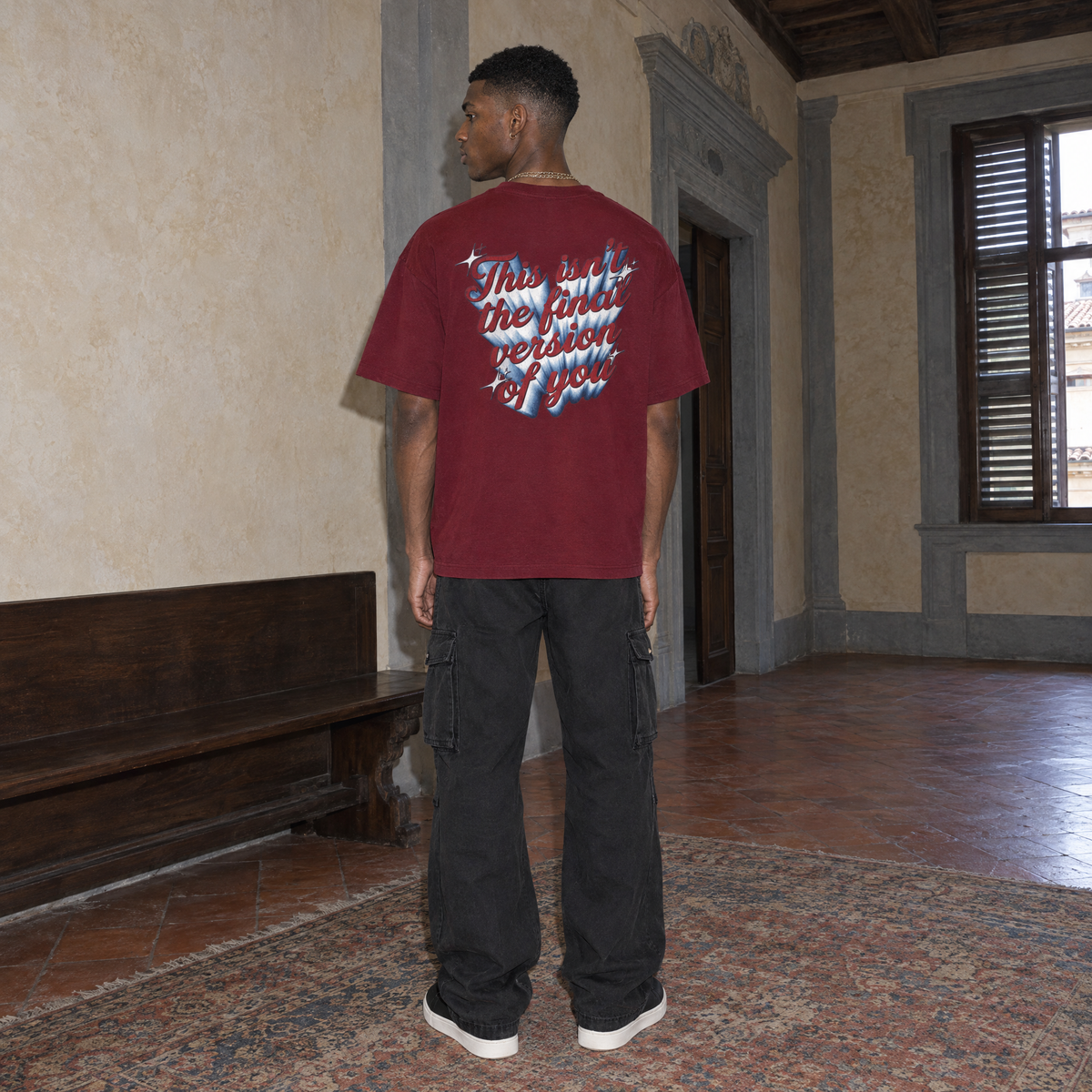 Man wearing the SERENOS Final Version T-Shirt in wine red, back print reading This isn't the final version of you