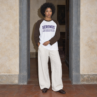 Woman wearing the Look raglan long sleeve by Serenos in white with coffee sleeves, front print reading you have to want it badly enough to look