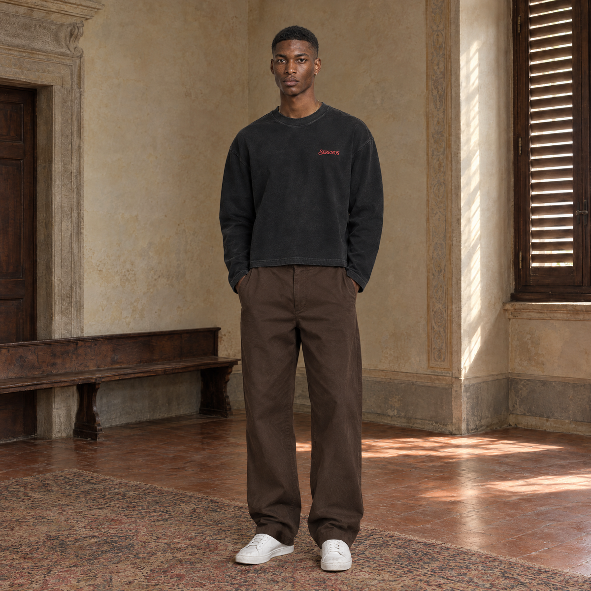 Man wearing the SERENOS Love long sleeve in black, front view with the small red chest logo