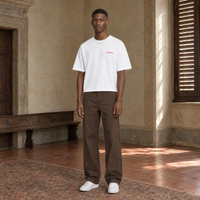 Man wearing the SERENOS Love T-Shirt in white, front view with the small red chest logo