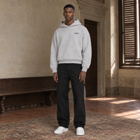 Man wearing the SERENOS Never Happens oversized boxy hoodie in flower gray, front view with the small navy chest logo, cropped boxy fit