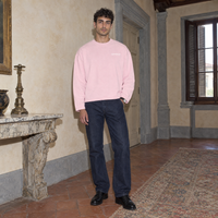 Man wearing the SERENOS Notes Long Sleeve in pink, front view with small chest logo
