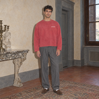 Man wearing the SERENOS Notes Long Sleeve in red, front view with small chest logo