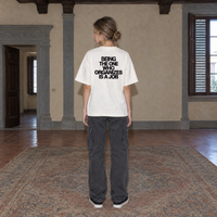 Woman wearing the white Organizes t-shirt from behind, bold black back print reading Being the one who organizes is a job