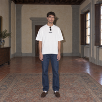 Man wearing the white Organizes t-shirt front view with the small black SERENOS chest logo