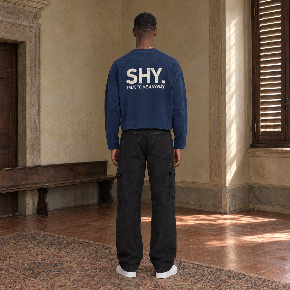 Man seen from behind wearing the SERENOS Shy long sleeve in navy blue, back print reading Shy, talk to me anyway