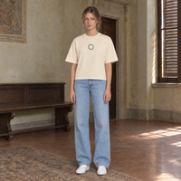 Woman wearing the SERENOS Shy T-Shirt in apricot, front view with the small ring logo at the centre of the chest
