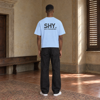 Man seen from behind wearing the SERENOS Shy T-Shirt in blue, back print reading Shy, talk to me anyway