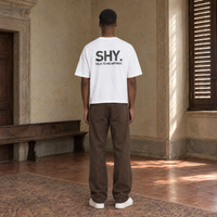 Man seen from behind wearing the SERENOS Shy T-Shirt in white, back print reading Shy, talk to me anyway