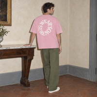 Man seen from behind wearing the pink Spiral oversized t-shirt by Serenos, circular Wear Serenos back print