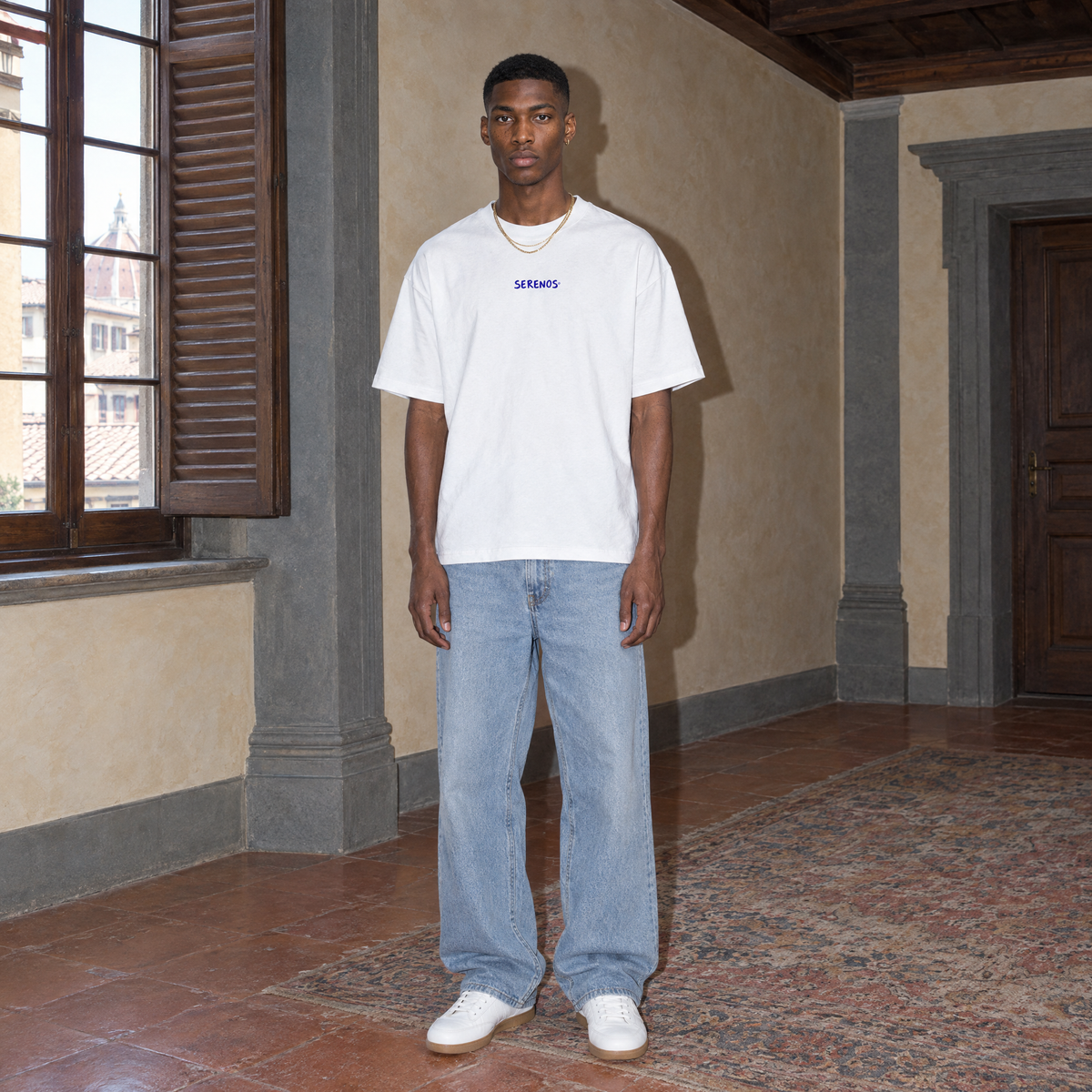 Man wearing the white Start Over t-shirt front view with the small blue SERENOS chest logo