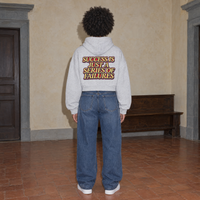 Woman wearing the SERENOS Success oversized boxy hoodie in flower gray, seen from behind showing the Success Is Just A Series Of Failures back print, cropped boxy fit
