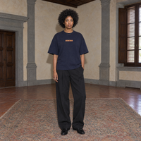 Woman wearing the SERENOS Success T-Shirt in navy blue, front view with centred chest logo