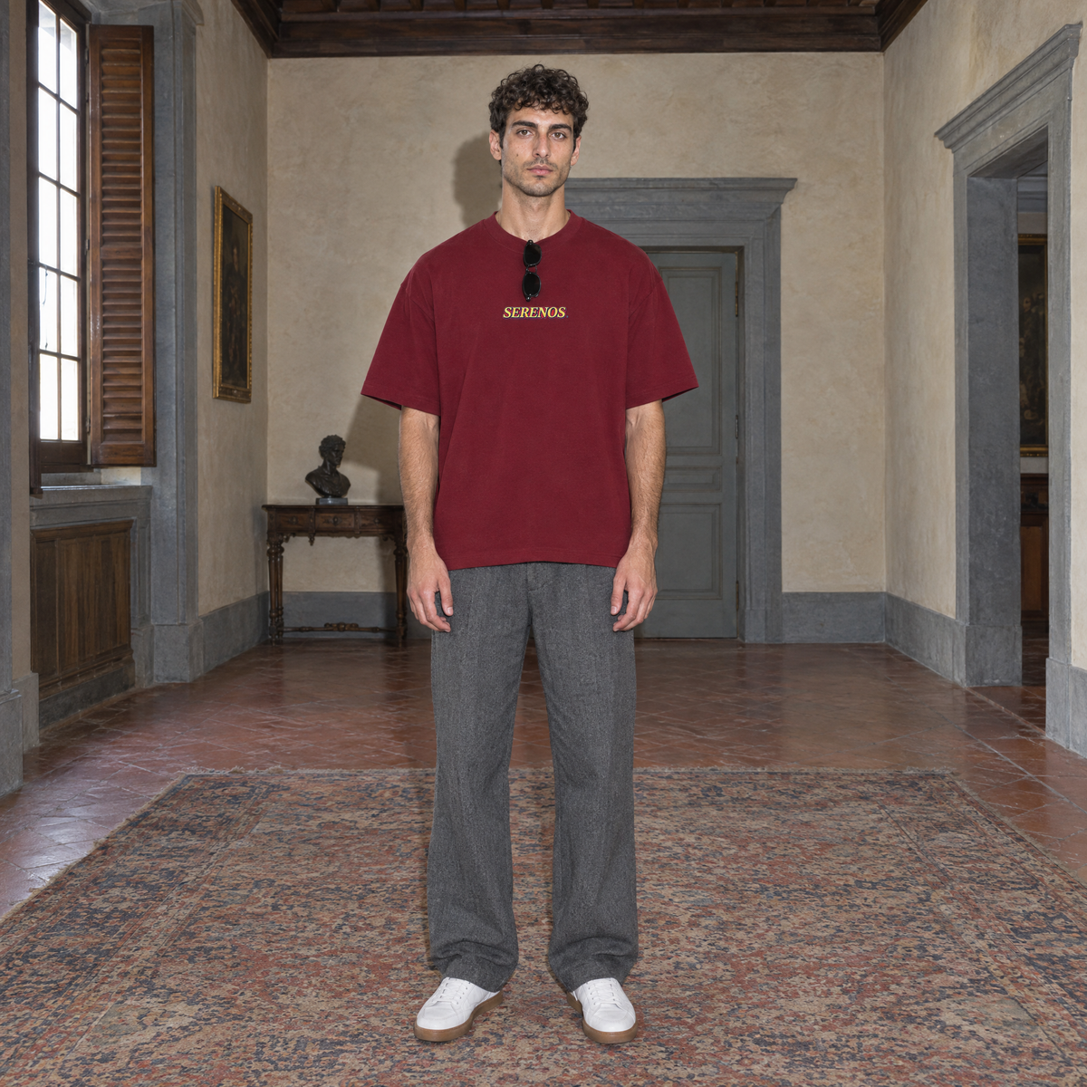 Man wearing the SERENOS Success T-Shirt in wine red, front view with centred chest logo