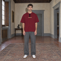 Man wearing the SERENOS Success T-Shirt in wine red, front view with centred chest logo