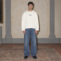 Man wearing the cream Yes long sleeve by Serenos, front view with the Serenos chest logo