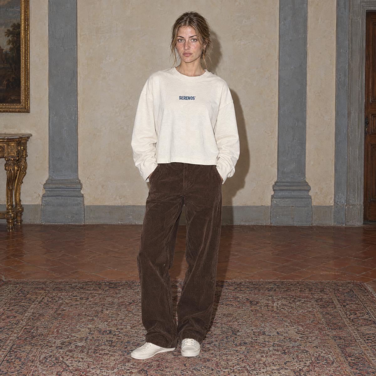 Woman wearing the cream Yes long sleeve by Serenos, front view with the Serenos chest logo